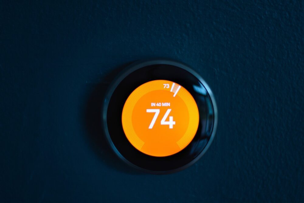 Smart thermostat on wall set to adjust temperature in 40 minutes