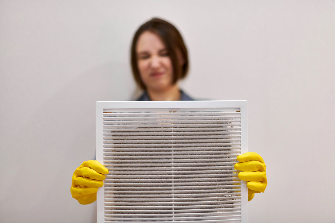 Woman Holding Dusty Air Vent